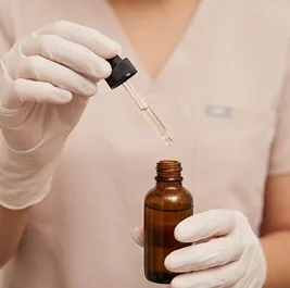 Nurse holding a serum dropper