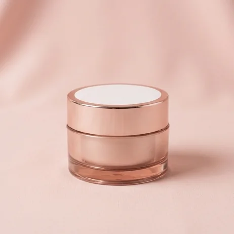 Rose-gold lidded cream jar on a blush backdrop