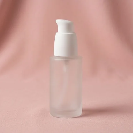 Frosted pump bottle on a dusty pink backdrop