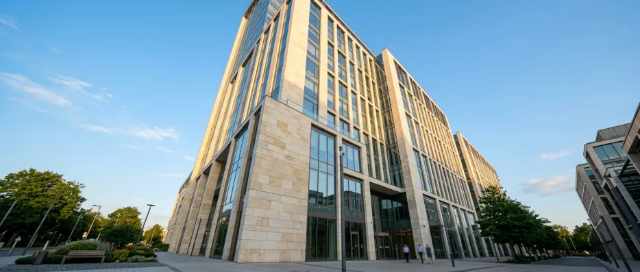 Pale stone and glass office tower seen from street level