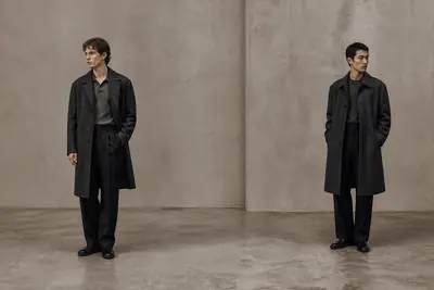 Two models in charcoal overcoats from the Skagen collection