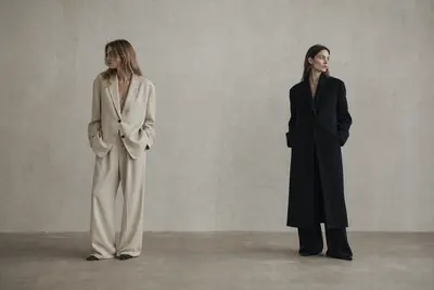 Two models in cream and black coats from the Loven collection