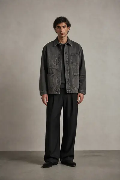 Model wearing a washed denim jacket with dropped shoulders