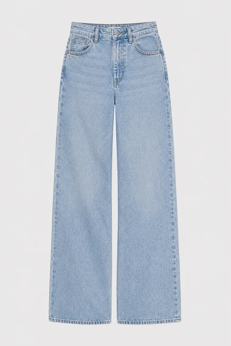 Light indigo straight-leg jeans photographed flat on a pale grey ground