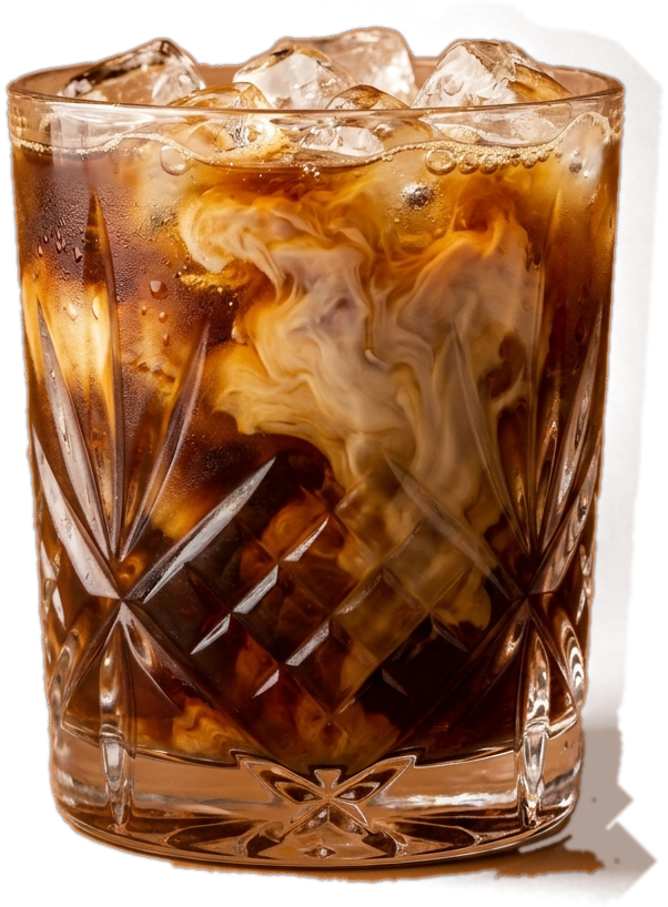 A cut glass tumbler of iced coffee with swirling milk