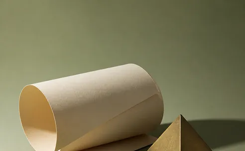 Rolled cream paper and a brass form on a sage backdrop