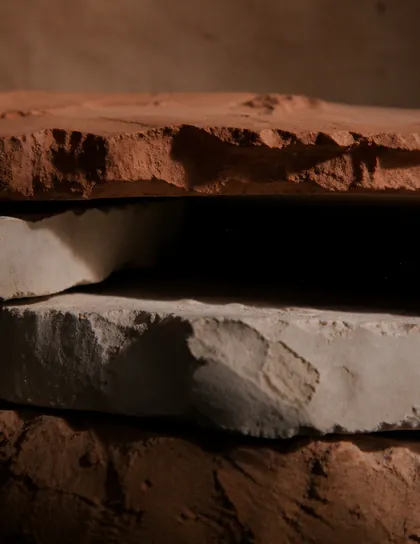 Layered terracotta clay slabs in raking light