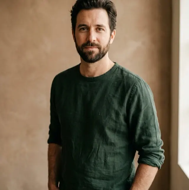 Portrait of an operations partner in a dark green shirt