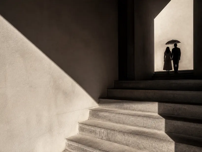 High contrast black and white photograph of a concrete stair and a hard diagonal shadow