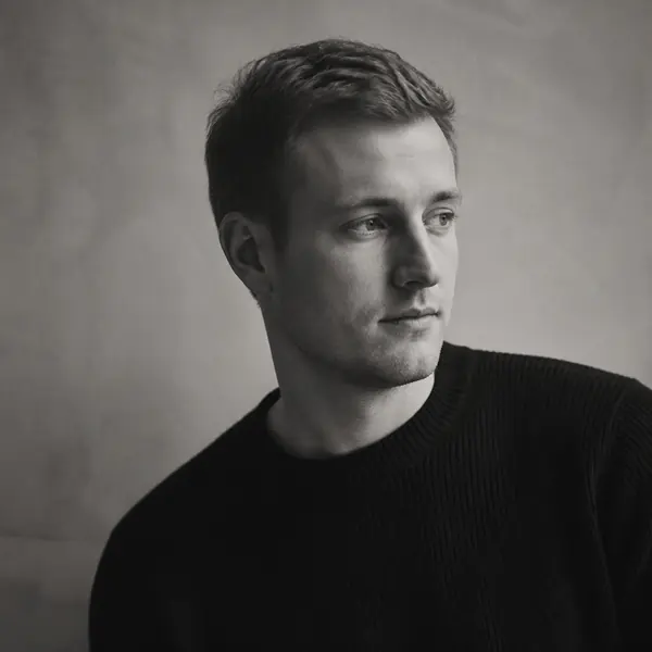 Studio portrait of a designer in a dark crew neck sweater
