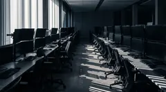 Hard morning sunlight through tall blinds across an empty trading room