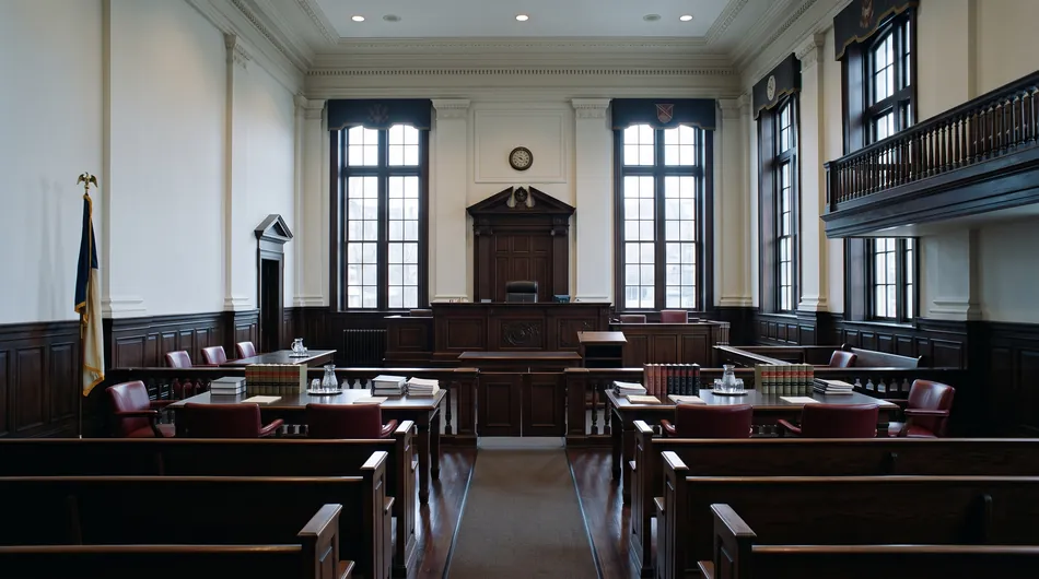 An empty courtroom with tall windows