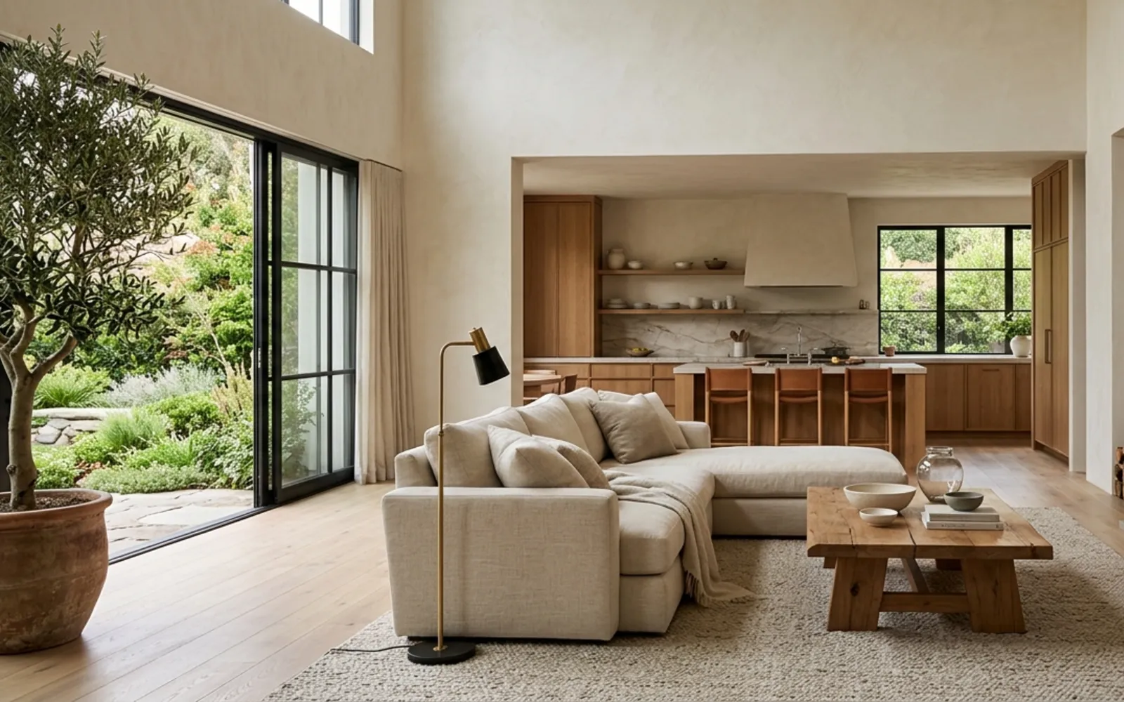 Living room with a linen sofa, a low oak table and tall windows