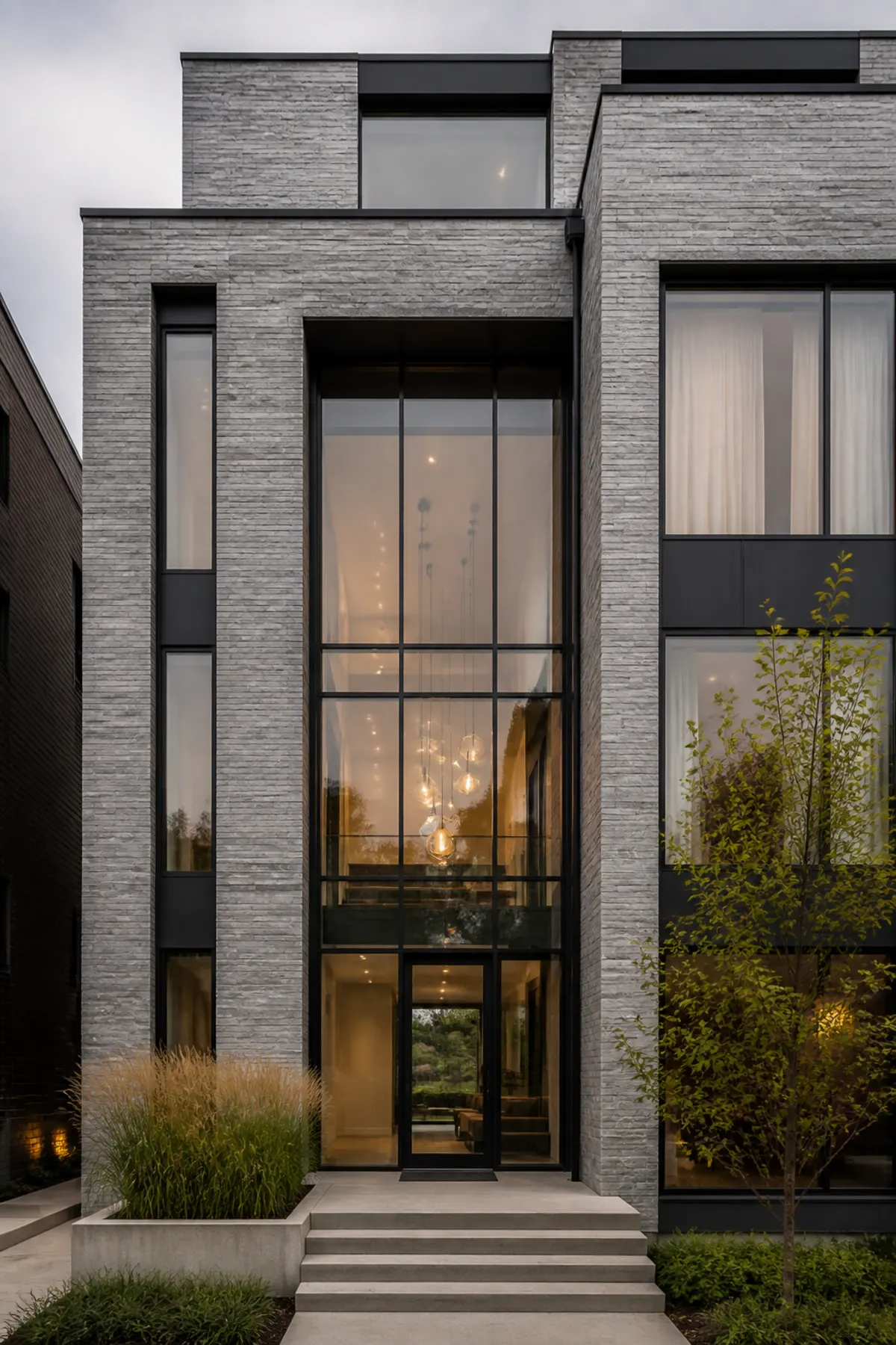 Grey stone townhouse with a double-height glazed entrance