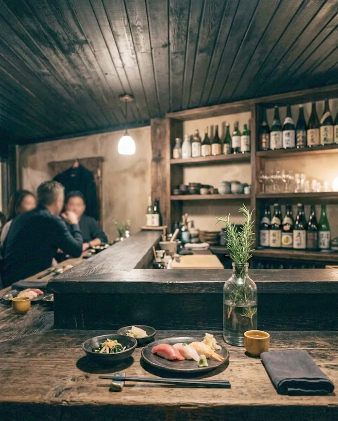 The counter room at dusk with a sprig of rosemary in a glass bottle