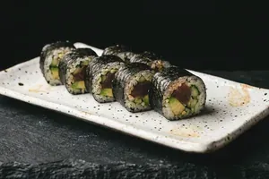 A cut roll arranged along a long speckled ceramic plate