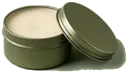 Round olive metal tin with the lid resting against it