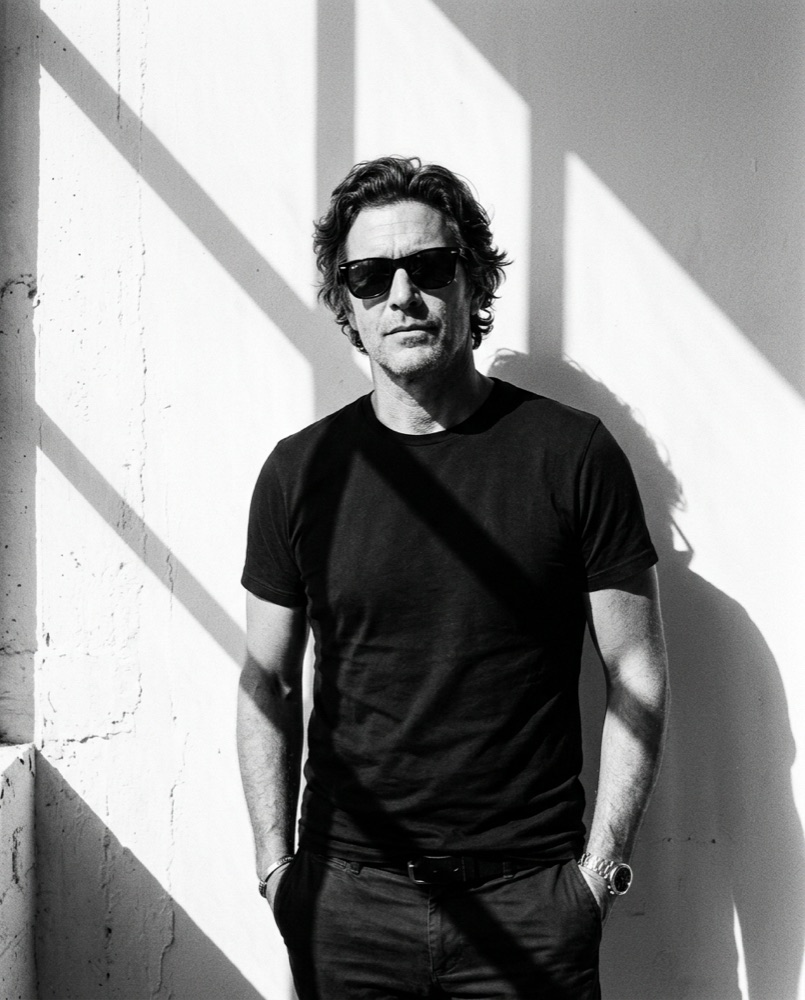 Theo Marlowe against a sunlit white wall