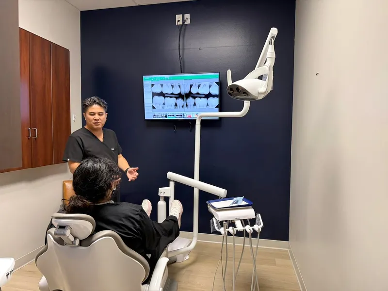 Dr. Chiem reviews a panoramic X-ray with a patient in the treatment room