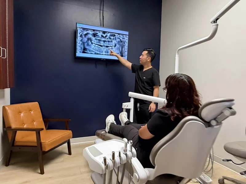 Dr. Tam points to a panoramic X-ray on the chairside screen