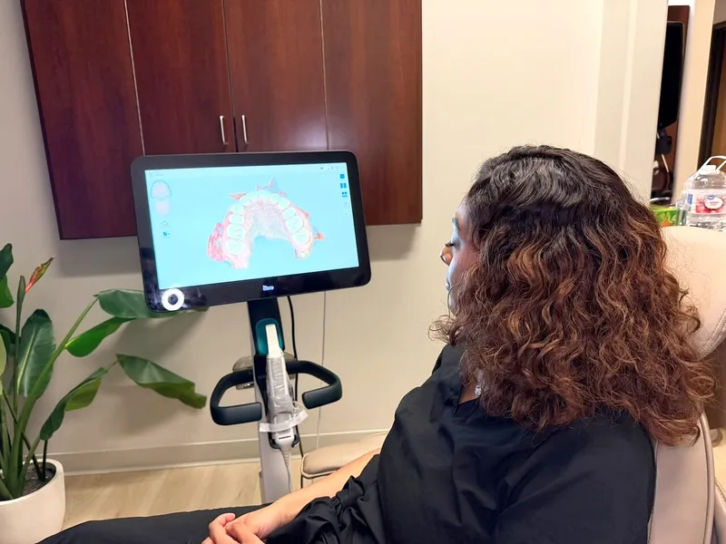 A patient watches her iTero scan appear on the screen