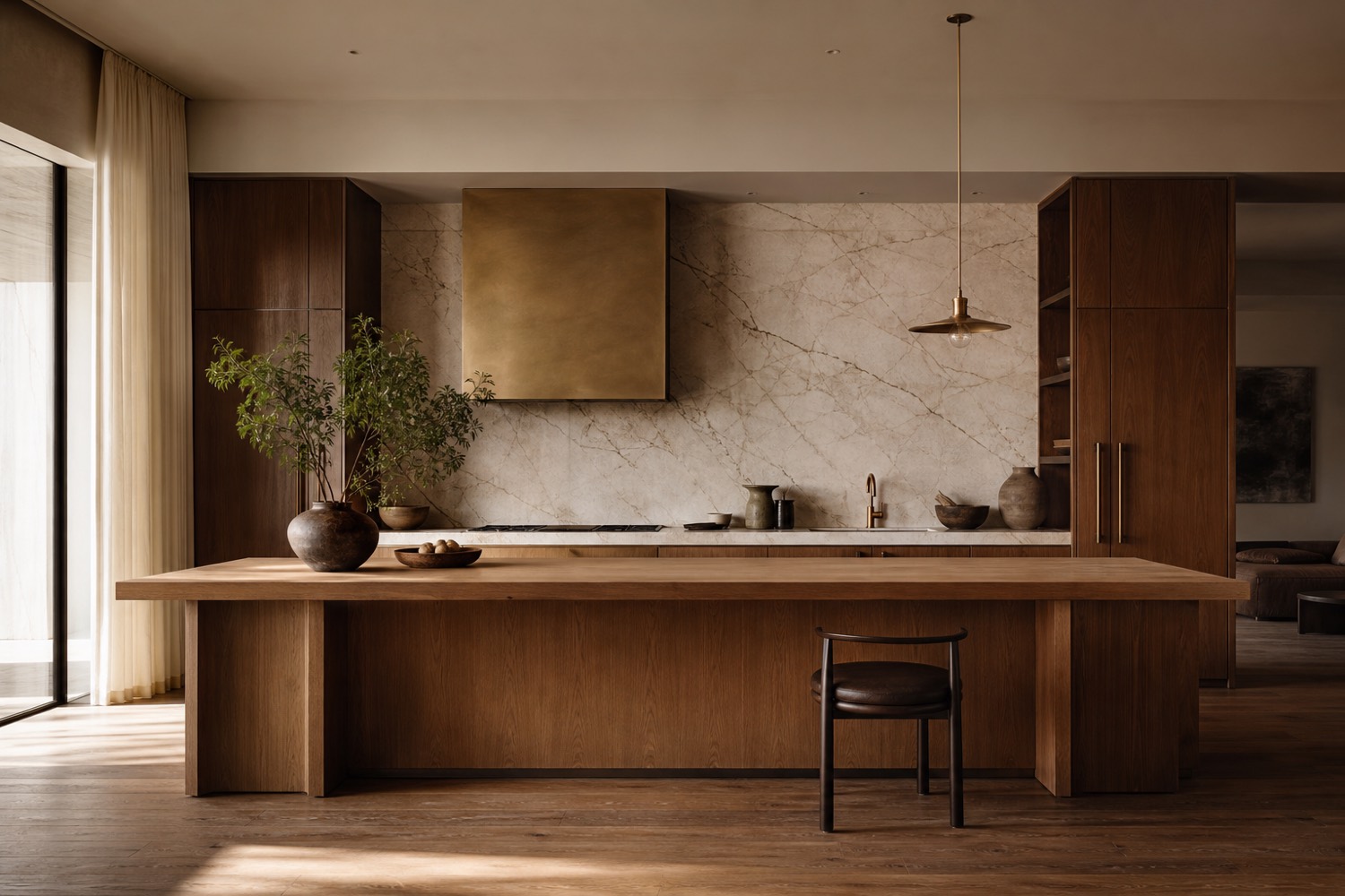 A wide view of a warm minimalist kitchen with a long oak island