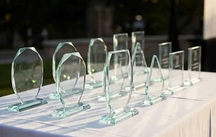 Row of plain glass trophies on a table