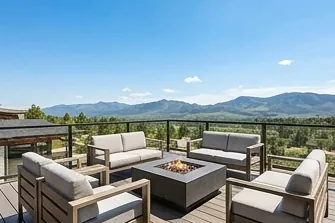 Rooftop deck with a fire table and mountain view