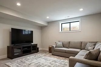 Lower-level den with a sectional sofa