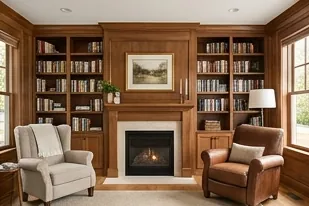 Den with built-in bookshelves and a fireplace