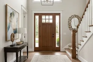 Entry foyer with a wood front door