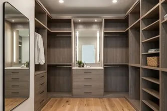 Walk-in closet with wood shelving