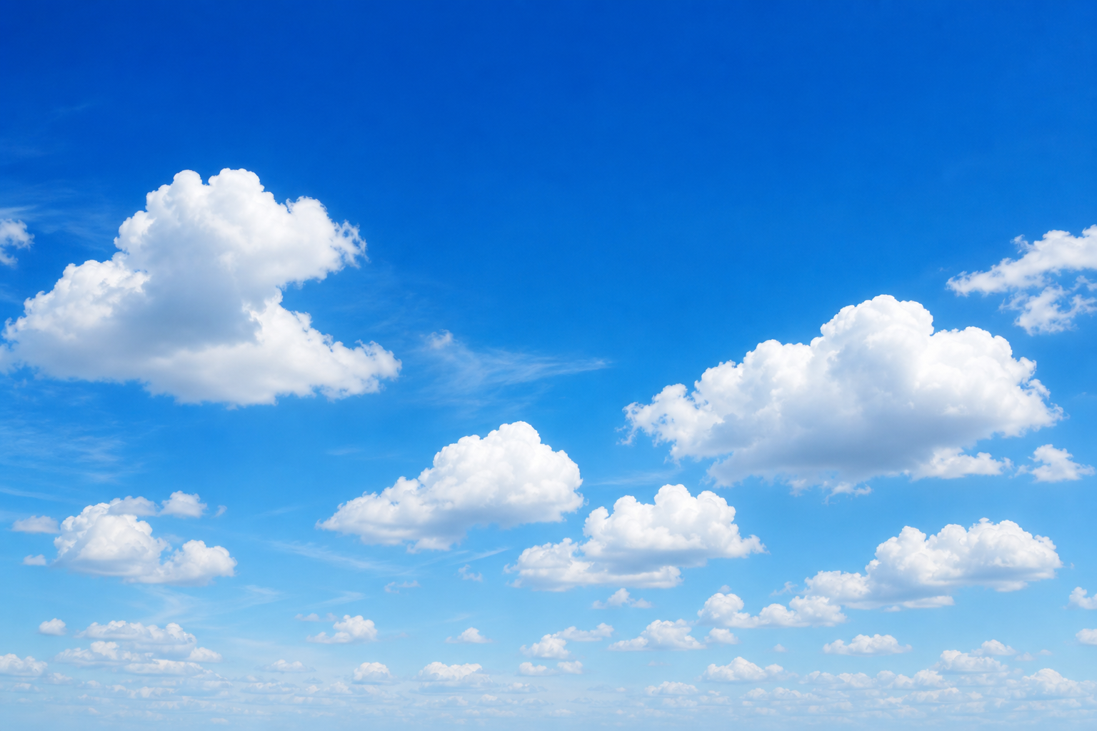 Bright blue sky with soft clouds