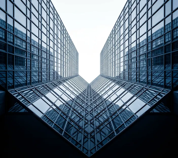 Looking up between two glass office towers