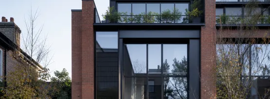 Brick and glass townhouse row on a quiet Brightwater street