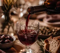 Red wine poured into a small glass