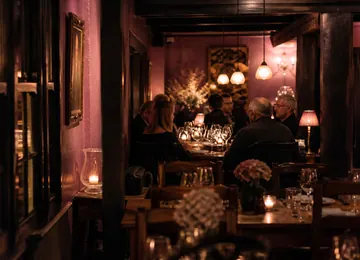 The dining room mid evening with candles on every table