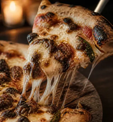 A blistered flatbread lifted from a wooden board